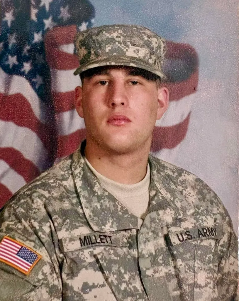 Newport community members gathering for a rally in support of a veteran facing legal charges, displaying signs of solidarity and advocacy