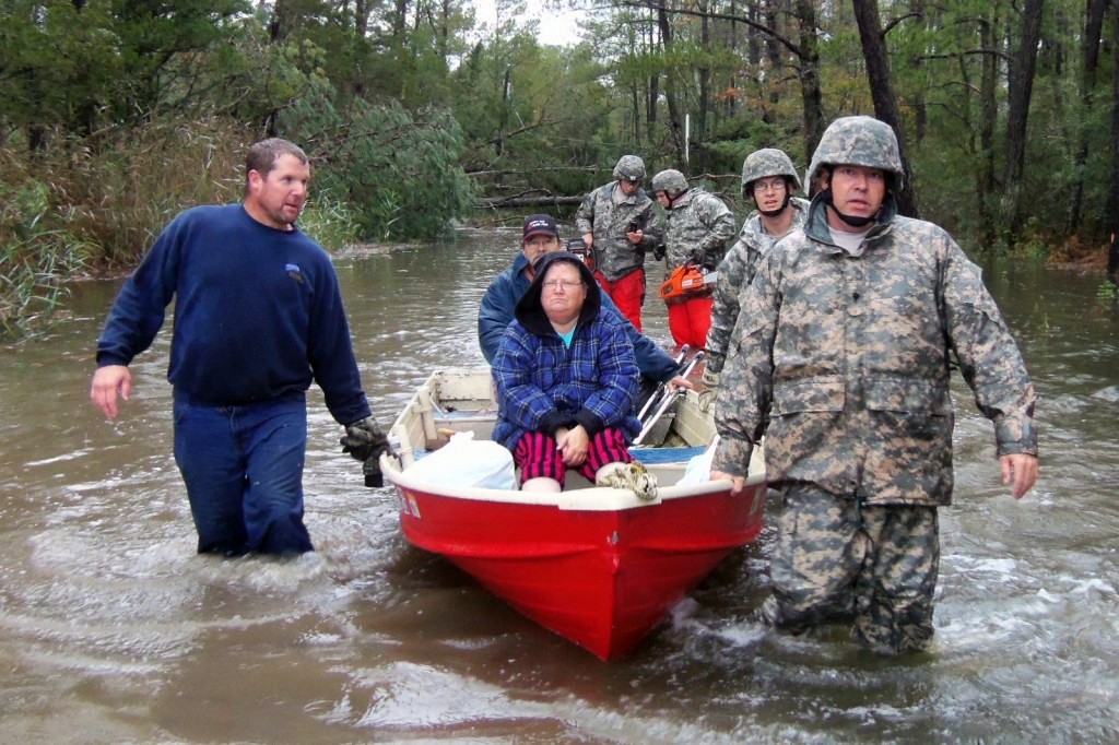 U.S. Military Veterans coordinating disaster relief efforts on the ground in a storm-damaged community