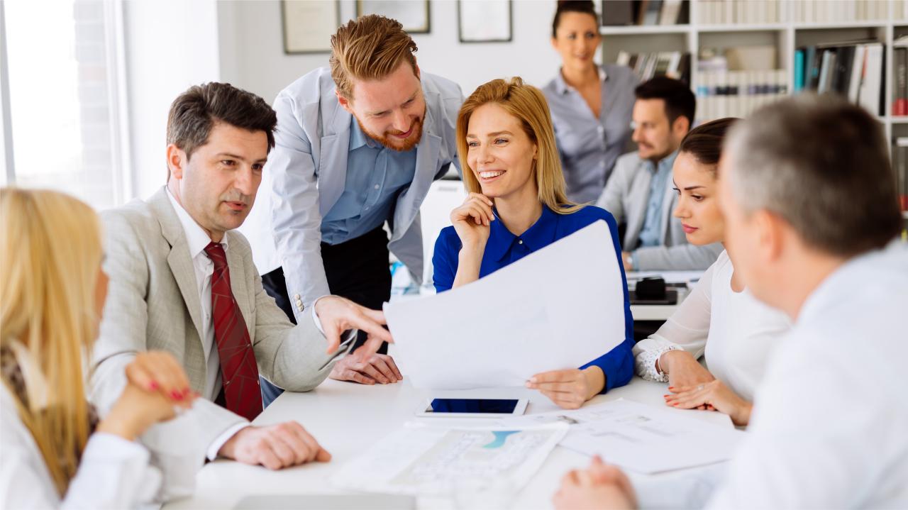 sales team collaborating on a structured AI CRM pilot program, reviewing adoption metrics